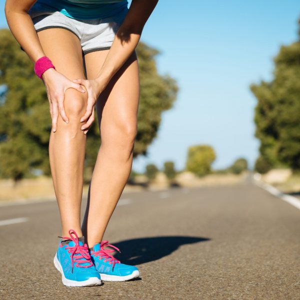 Female runner knee injury and pain.